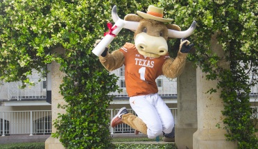 UT mascot Hook 'Em jumps for joy with diploma in hand
