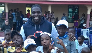 Texas Ex Sam Acho hands out NFL hats to children in Nigeria