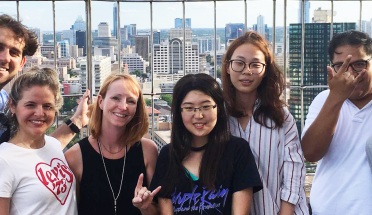 ELC teacher Dara Chambers smiles with students overlooking Austin