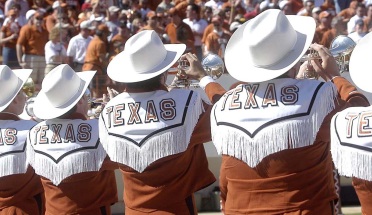 5 trumpeters from Longhorn Band show off their fringe and hats