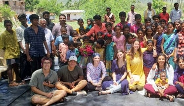 Volunteers from Projects with Underserved Communities pose with community members in India
