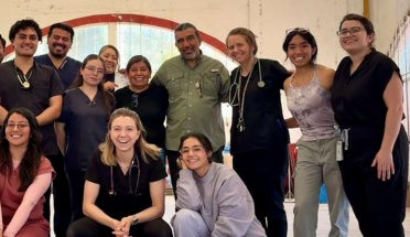Medical students pose for a group photo at a conference.