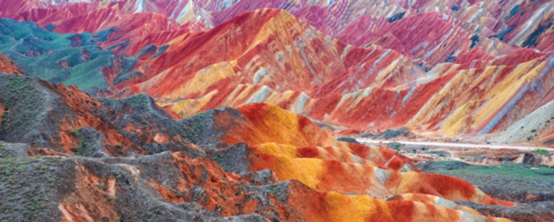 a crop of multi-colored mountains due to layers of various mineral deposits