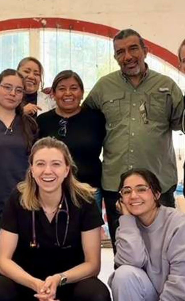 Medical students pose for a group photo at a conference.