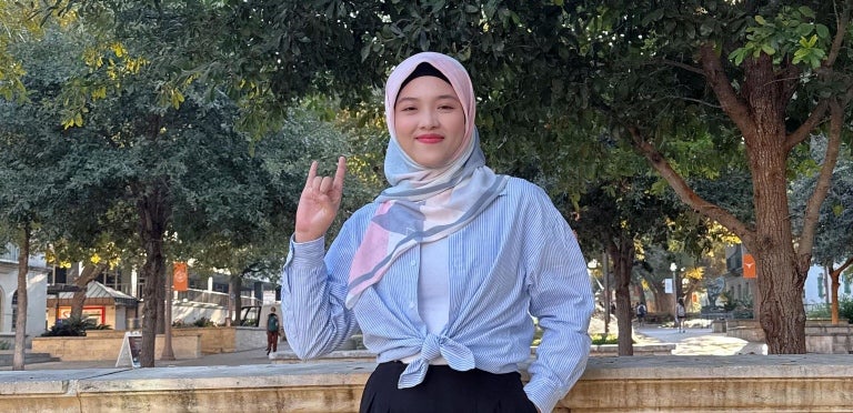 Sleh, a YSEALI 2024 participant smiles and shows her Longhorn pride