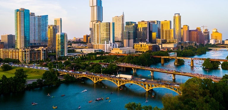 Aerial view of the Austin city skyline with the Lady Bird lake in view