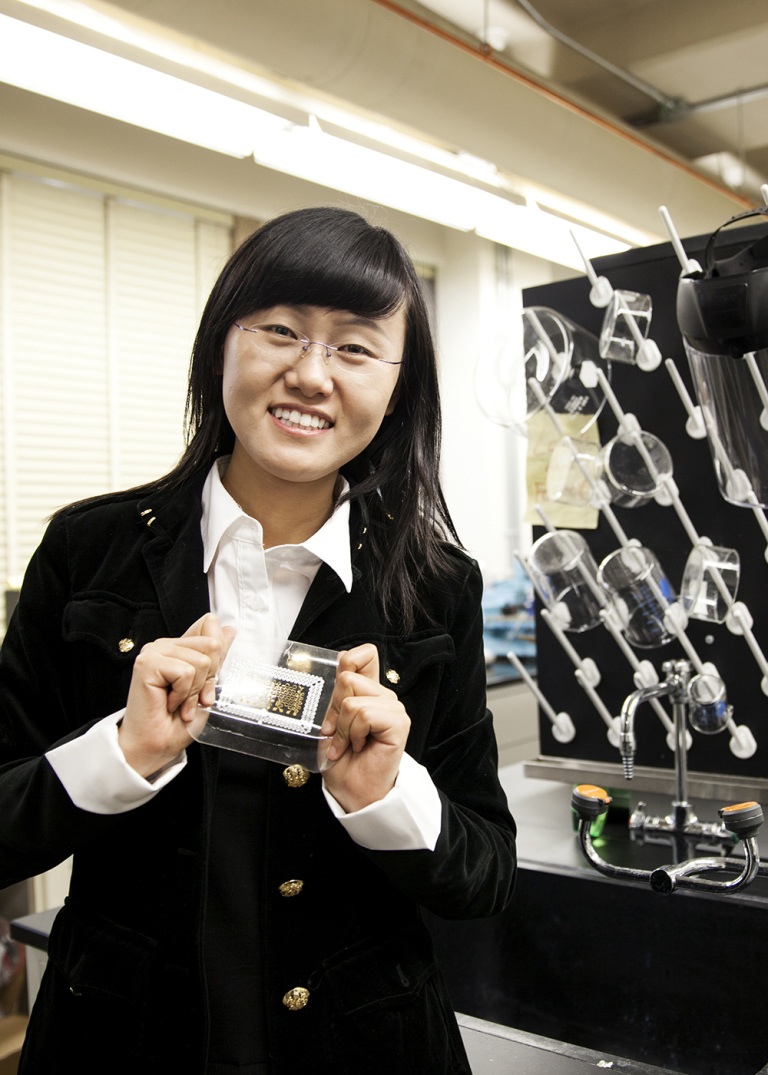 Nanshu Lu Holds up her research in her lab