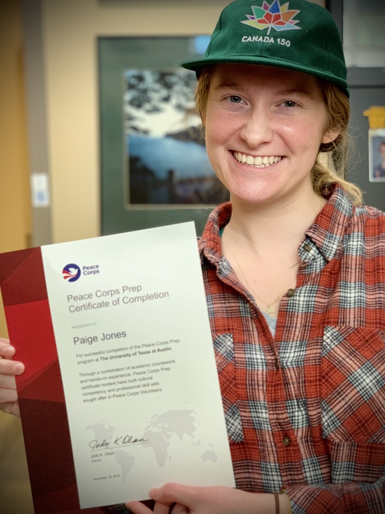 Alumna Paige Jones holds her Peace Corps Prep certificate 