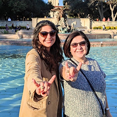 Valeria Colunga and Martha Lozano in front of the UT fountain