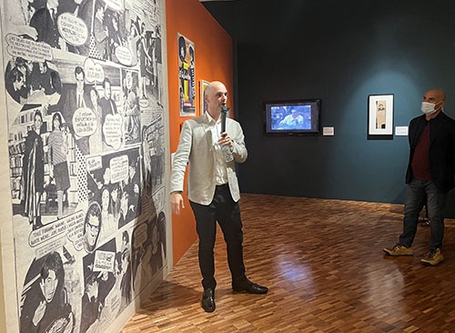 HRC curator Álvaro Santana-Acuña with graphic prints of García Márquez works
