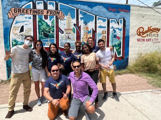 Young Leaders of the Americas 2022 cohort in front of the Welcome to Austin postcard sign