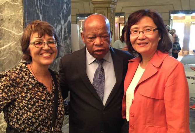 Dr. Loriene Roy stands with John Lewis and Min Chou
