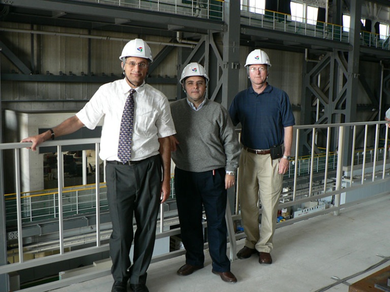 Sergio Alcocer stands with 2 other engineers wearing hardhats