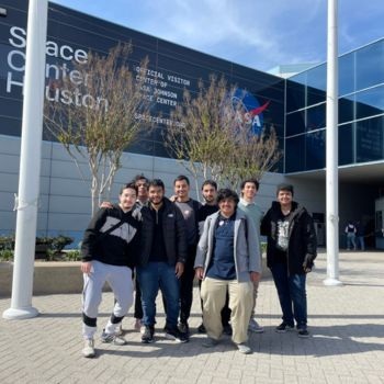 SABIC students smile in front of the Space Center in Houston