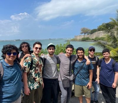 Students smile in front of a scenic view in Puerto Rico