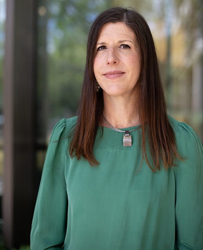 Moody Communications professor Stacey Sowards in a green top