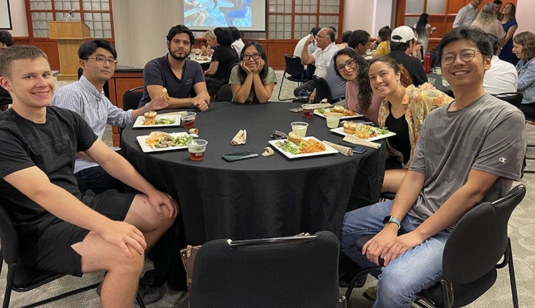 Adolfo with other students at a restaurant 