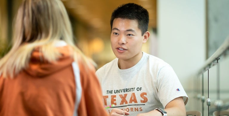 Two UT students having a discussion