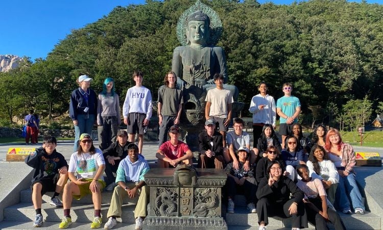 Students in front of buddha statue in South Korea. 