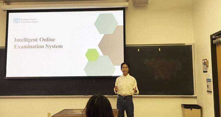ELC student Yang Shao presents in front of a classroom