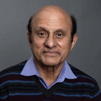 UT Professor Vijay Mahajan smiles for a portrait