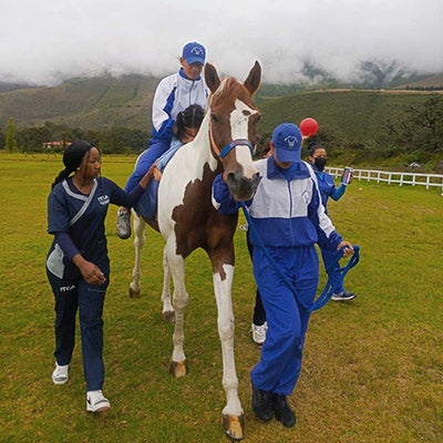 Police officers volunteer with children and horses in Ecuador