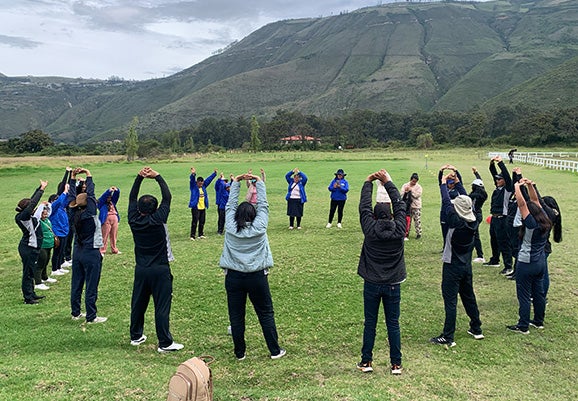 Volunteers work clients through stretching exercises. 