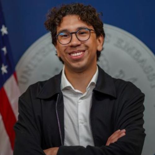 profile headshot of peer mentor Juan Rocha Gomez smiling with arms crossed