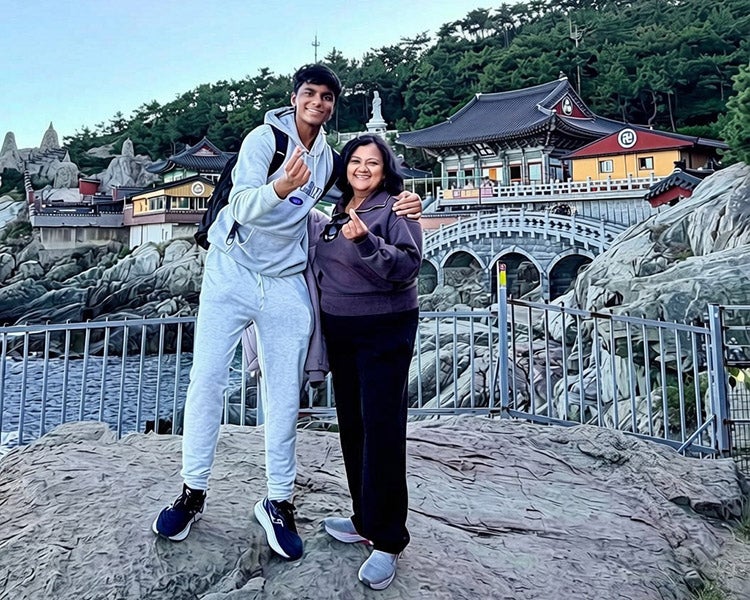 2024 Take the World by the Horns student Jeremy Thomas poses with his mother in Korea