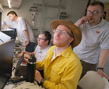Members of UT's XPRIZE team monitor an aircraft flight from the ground